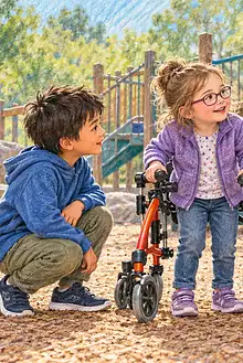 Caregiver guiding a respectful conversation between children beside a mobility walker