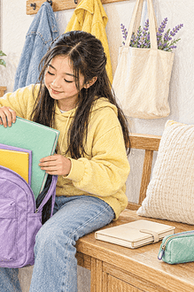 Child using colour-coded folders while a caregiver points to a simple backpack checklist